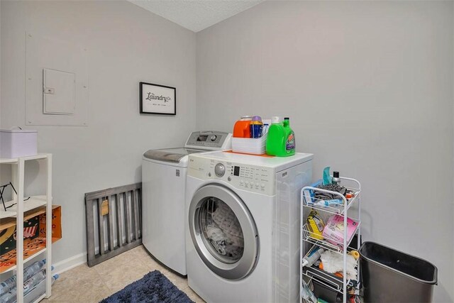 clothes washing area with a textured ceiling and washing machine and clothes dryer