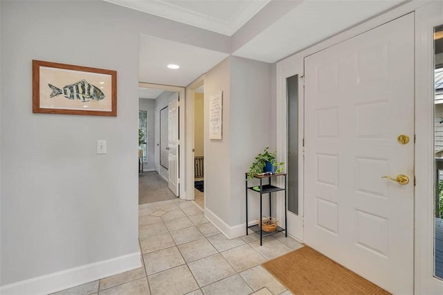 tiled entrance foyer with a healthy amount of sunlight