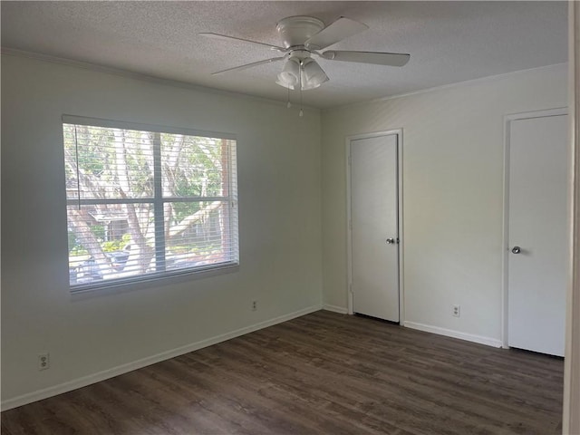800 Mallery St Unit C-30, Saint Simons Island, GA 31522 - unfurnished bedroom with a textured ceiling, dark wood-style floors, ornamental molding, baseboards, and ceiling fan