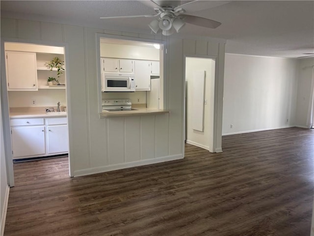 800 Mallery St Unit C-30, Saint Simons Island, GA 31522 - kitchen featuring white microwave, range, white cabinets, a sink, and open floor plan