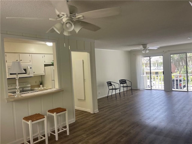 800 Mallery St Unit C-30, Saint Simons Island, GA 31522 - kitchen featuring white appliances, ceiling fan, white cabinetry, and dark wood-style flooring
