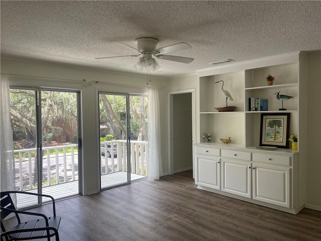 800 Mallery St Unit C-30, Saint Simons Island, GA 31522 - unfurnished room featuring a textured ceiling, ceiling fan, and dark wood-style flooring