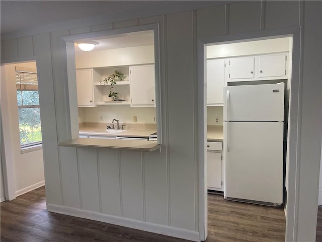 800 Mallery St Unit C-30, Saint Simons Island, GA 31522 - kitchen with freestanding refrigerator, light countertops, dark wood-type flooring, white cabinetry, and a sink