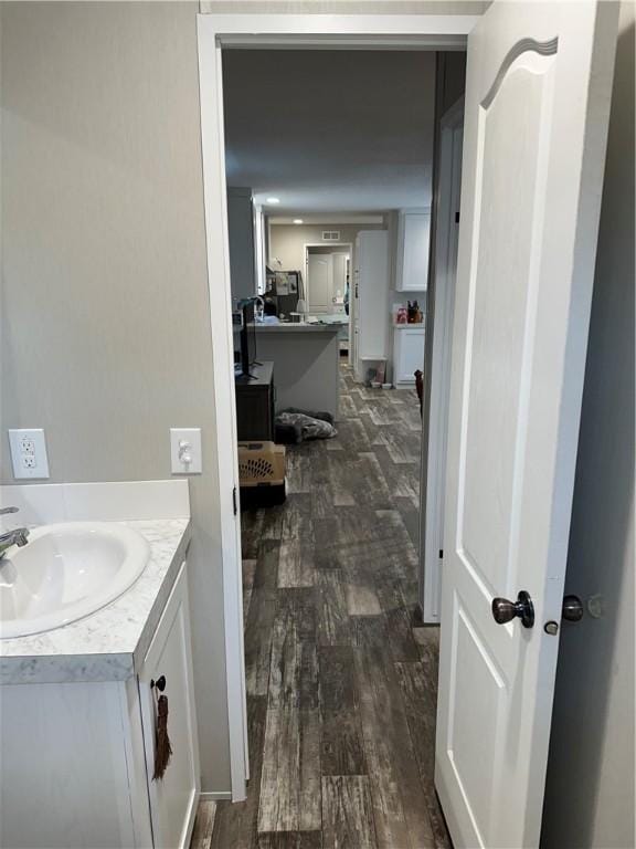 bathroom with hardwood / wood-style flooring and vanity