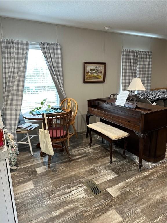 sitting room with dark hardwood / wood-style flooring and a textured ceiling