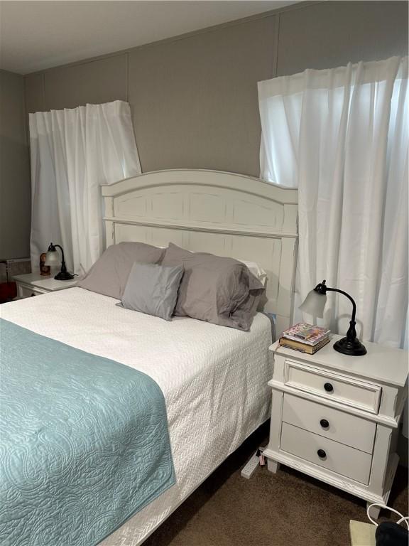 bedroom featuring dark colored carpet