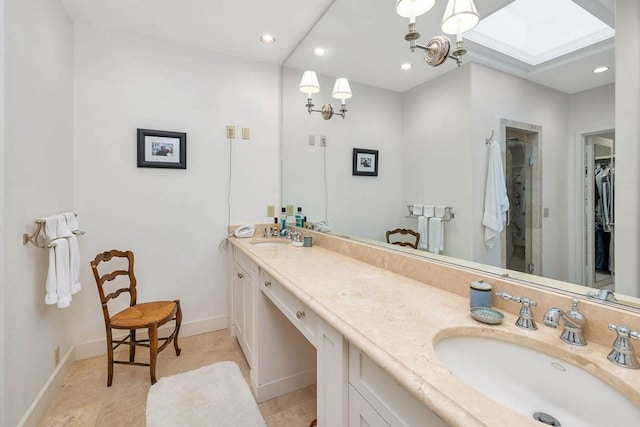 bathroom with vanity and a skylight