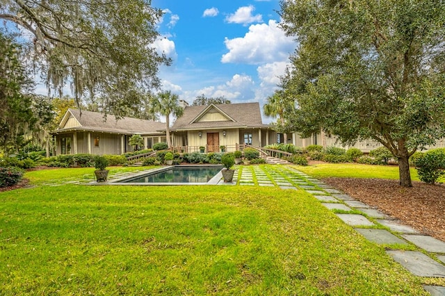 rear view of property featuring a yard