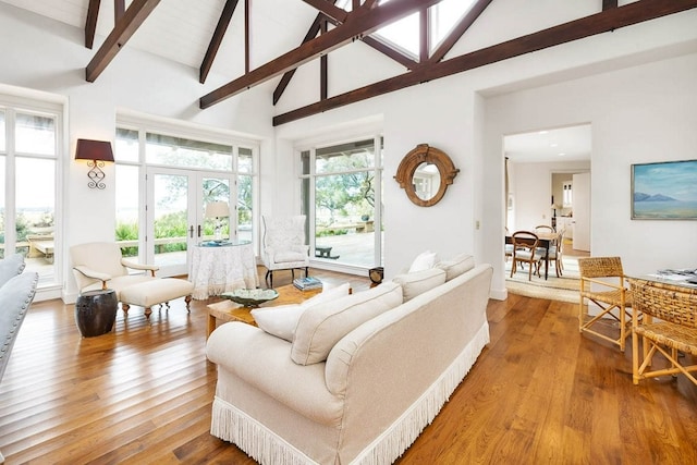 living room with french doors, wood-type flooring, beam ceiling, and high vaulted ceiling