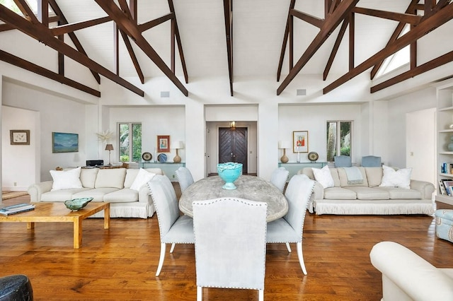 dining room with hardwood / wood-style flooring and lofted ceiling with beams