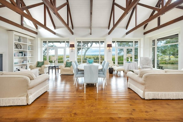 sunroom with vaulted ceiling with beams and french doors