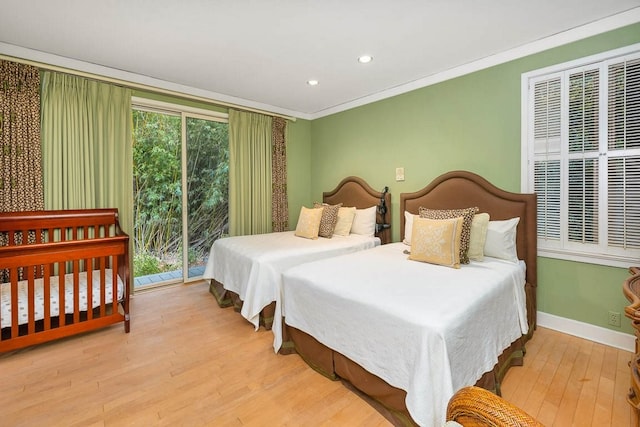 bedroom with crown molding, access to exterior, and light wood-type flooring