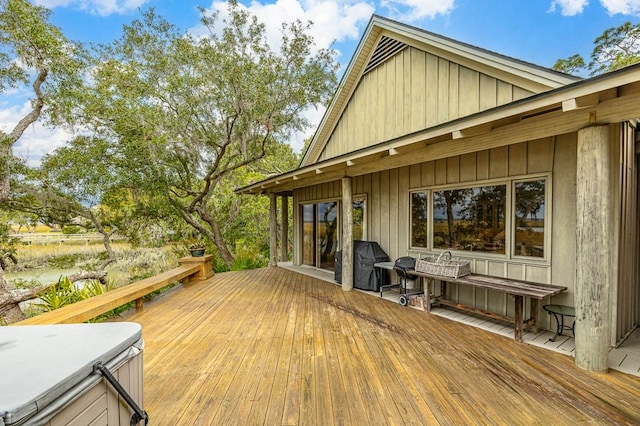 deck featuring area for grilling and a hot tub