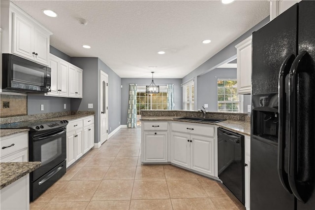 kitchen with white cabinets, sink, decorative light fixtures, and black appliances