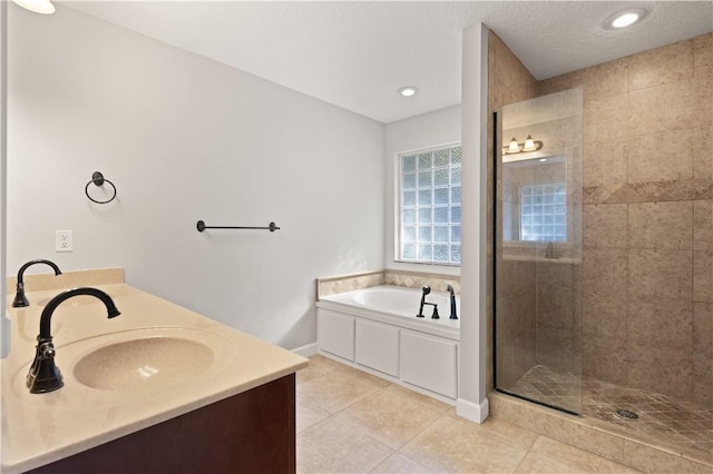 bathroom featuring tile patterned floors, vanity, separate shower and tub, and a textured ceiling