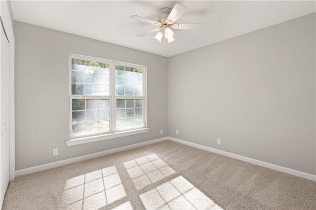 empty room featuring light carpet and ceiling fan