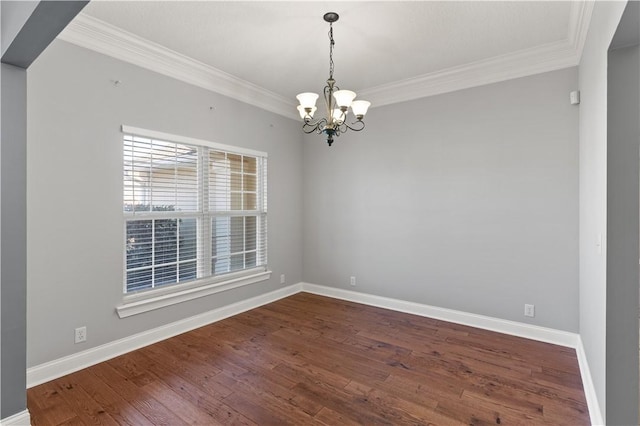 spare room featuring crown molding, hardwood / wood-style floors, and a chandelier