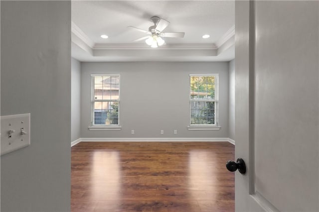 unfurnished room featuring plenty of natural light, dark wood-type flooring, and ornamental molding