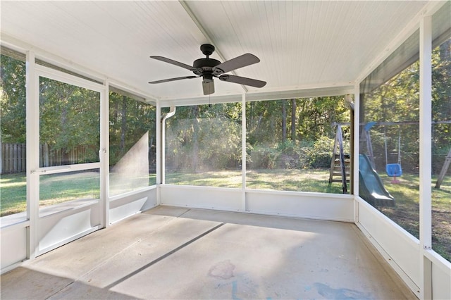 unfurnished sunroom with ceiling fan