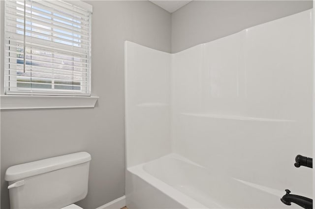 bathroom with shower / bathing tub combination, toilet, and plenty of natural light