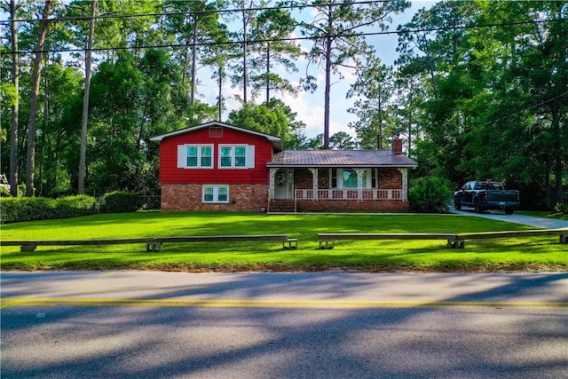 1206 Morningside Dr, Waycross, GA 31501 - tri-level home with covered porch, a front lawn, a chimney, and brick siding