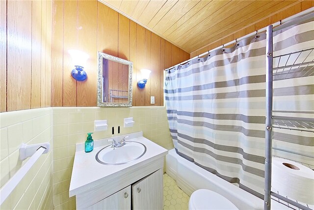 1206 Morningside Dr, Waycross, GA 31501 - full bathroom featuring vanity, shower / bath combo, wood ceiling, wood walls, and tile walls