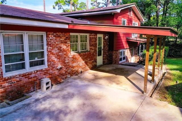 1206 Morningside Dr, Waycross, GA 31501 - view of front of home with a patio area, brick siding, and concrete driveway