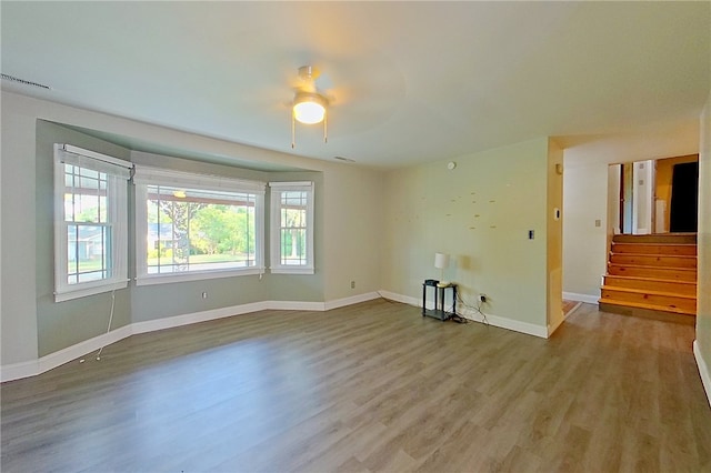 1206 Morningside Dr, Waycross, GA 31501 - unfurnished room with ceiling fan, wood finished floors, and stairs