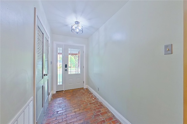 1206 Morningside Dr, Waycross, GA 31501 - foyer entrance featuring brick flooring and baseboards