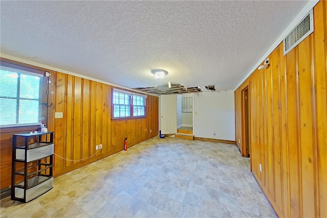 1206 Morningside Dr, Waycross, GA 31501 - spare room with wooden walls and a textured ceiling