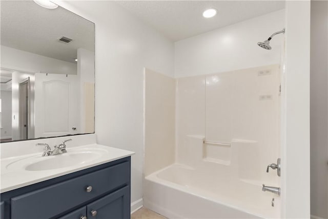 full bathroom with visible vents, a textured ceiling, washtub / shower combination, and vanity