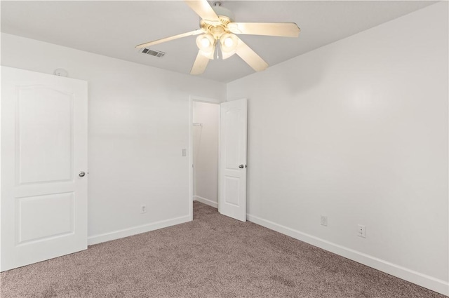 unfurnished bedroom featuring visible vents, baseboards, carpet, and a ceiling fan