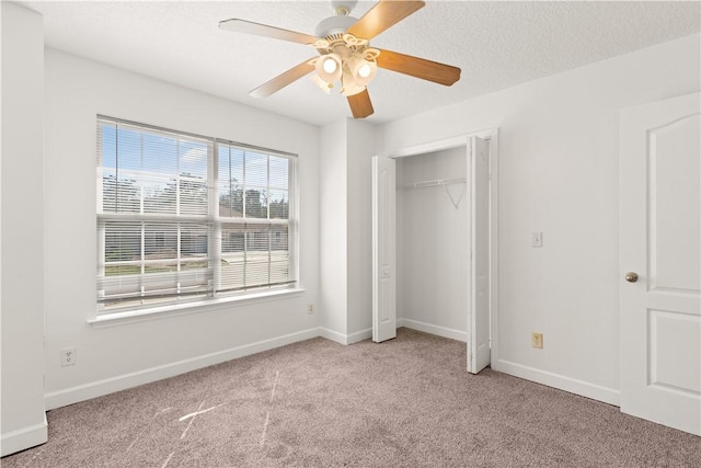 unfurnished bedroom featuring a textured ceiling, baseboards, and carpet floors