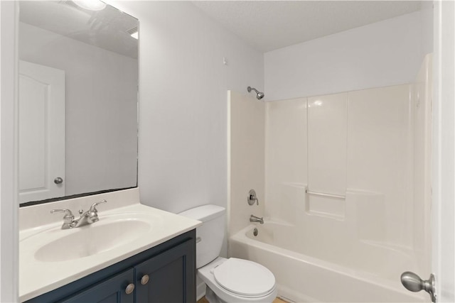 bathroom featuring vanity,  shower combination, and toilet