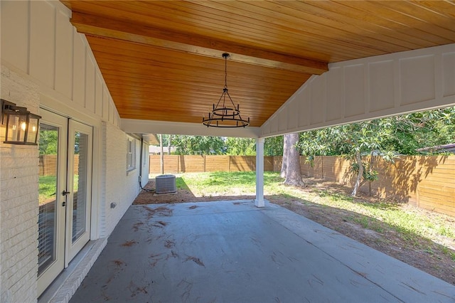 155 Mcdowell Ave, Brunswick, GA 31525 - fenced backyard with a patio, french doors, and central AC unit