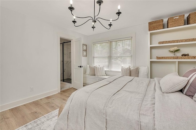 155 Mcdowell Ave, Brunswick, GA 31525 - bedroom featuring wood finished floors, a chandelier, baseboards, and ensuite bathroom
