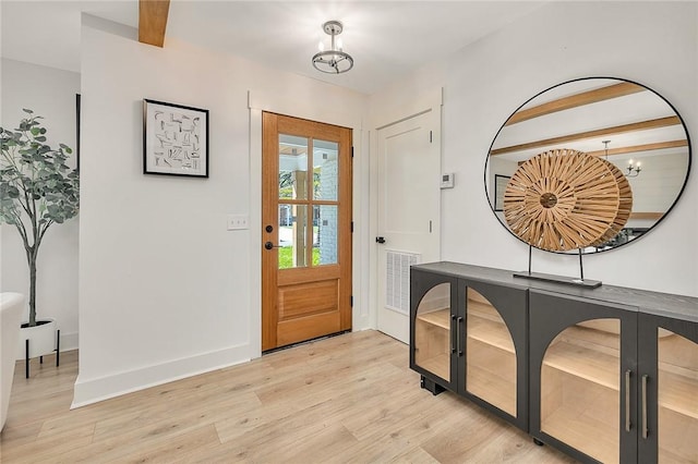 155 Mcdowell Ave, Brunswick, GA 31525 - entrance foyer with light wood finished floors, baseboards, and beam ceiling