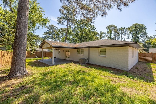 155 Mcdowell Ave, Brunswick, GA 31525 - rear view of house featuring brick siding, a patio area, and cooling unit