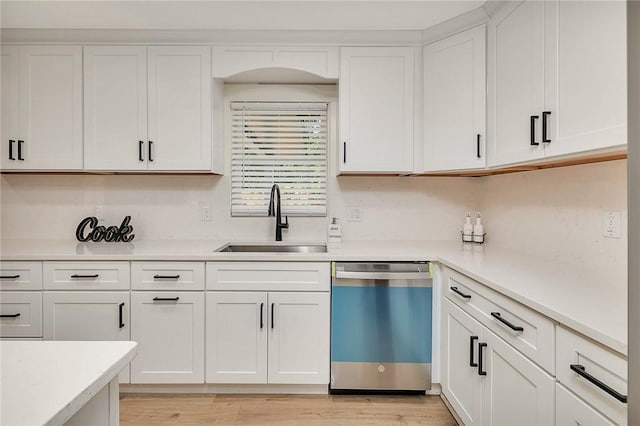 155 Mcdowell Ave, Brunswick, GA 31525 - kitchen with dishwashing machine, a sink, light countertops, and white cabinets