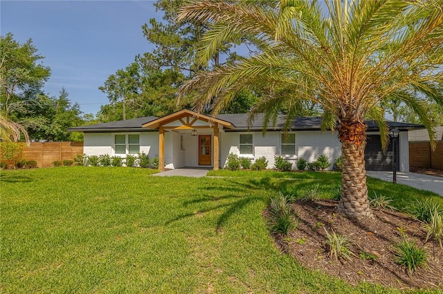 155 Mcdowell Ave, Brunswick, GA 31525 - view of front of property with roof mounted solar panels and stucco siding