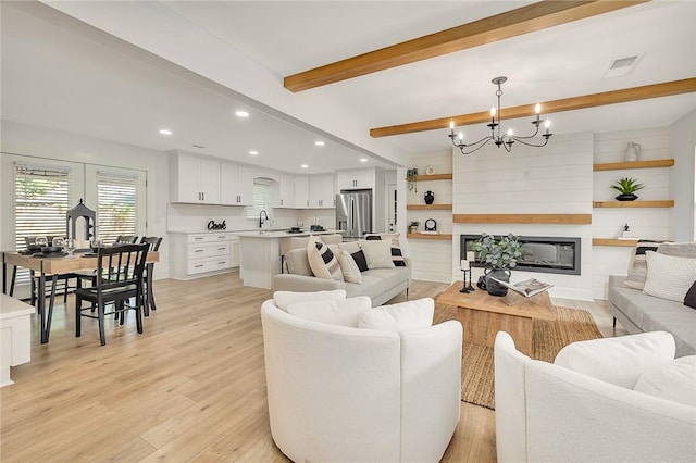 155 Mcdowell Ave, Brunswick, GA 31525 - living room with beamed ceiling, a chandelier, light wood-style flooring, recessed lighting, and a fireplace