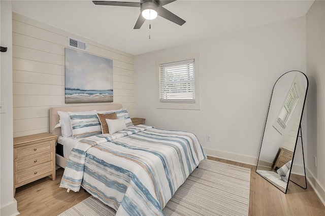 155 Mcdowell Ave, Brunswick, GA 31525 - bedroom with light wood finished floors, wood walls, baseboards, and a ceiling fan