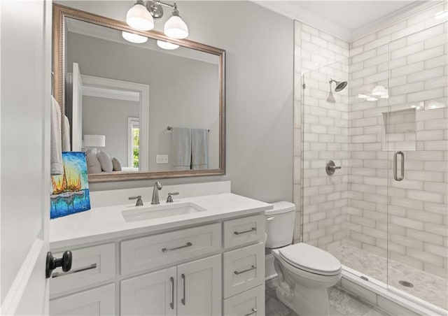 bathroom with toilet, vanity, ornamental molding, and a stall shower