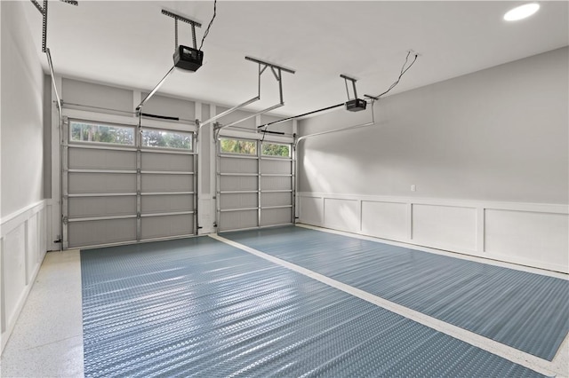 garage featuring wainscoting and a garage door opener