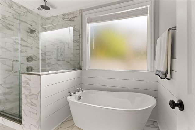 full bath with marble finish floor, a stall shower, and a soaking tub