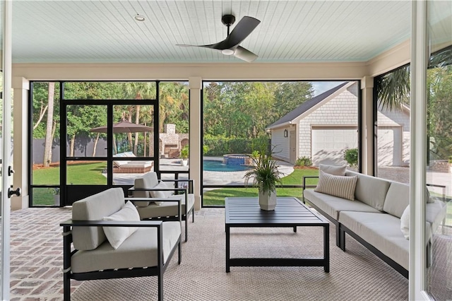 sunroom with a ceiling fan, a hot tub, and an outdoor living space