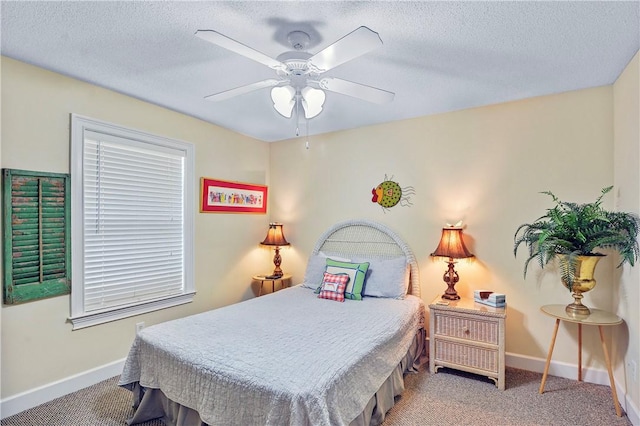 bedroom with baseboards, carpet flooring, a textured ceiling, and a ceiling fan