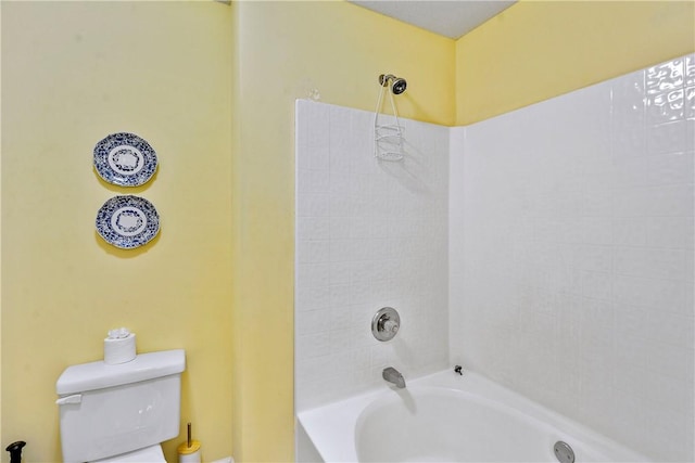 bathroom featuring toilet and tub / shower combination