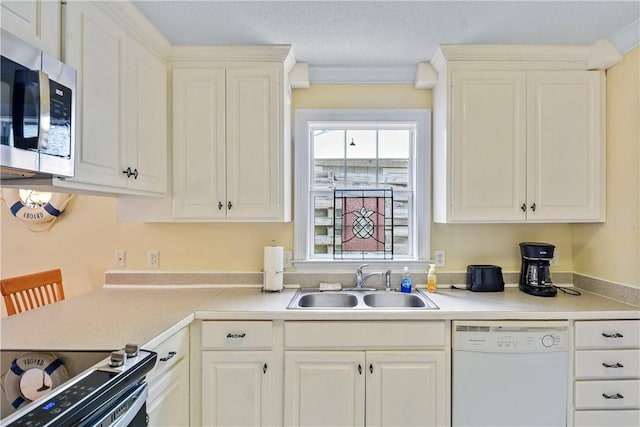kitchen with white dishwasher, a sink, light countertops, stainless steel microwave, and range with electric stovetop