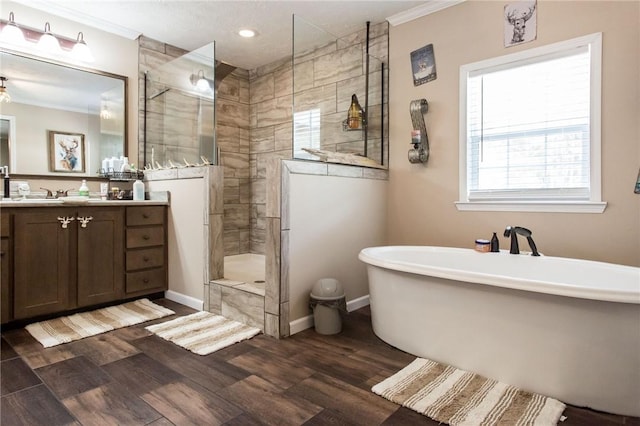 5618 Bowen Rd, Blackshear, GA 31516 - bathroom with ornamental molding, vanity, a freestanding tub, walk in shower, and wood finished floors